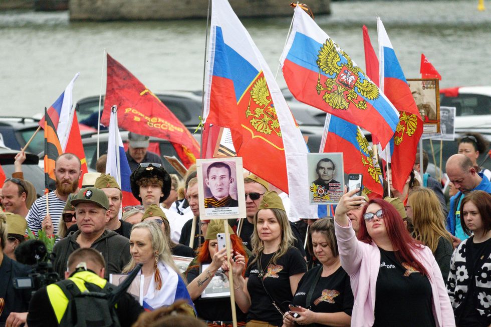 Participants of a pro-Russia demonstration through the city center partly carry the flag of Russia in North Rhine-Westphalia, Cologne.