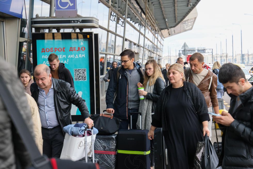 Passengers are seen at Vnukovo International Airport in Moscow