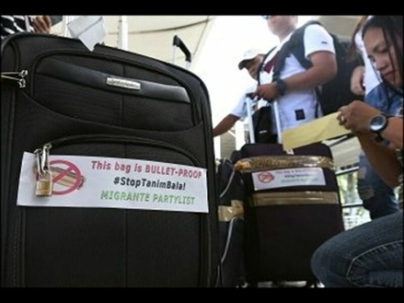 Passengers at Manila airport with anti-scam stickers.