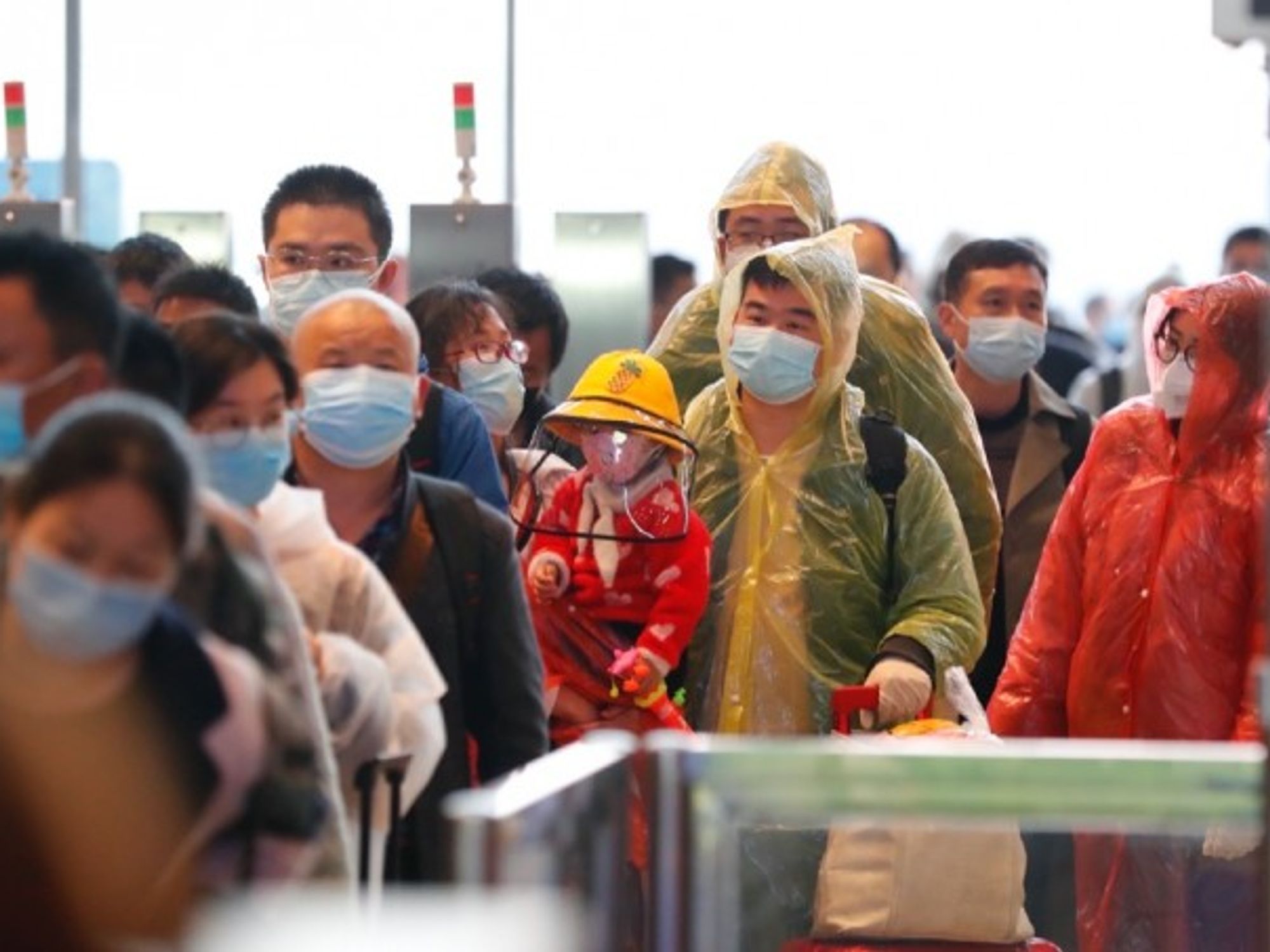 Passengers line up to enter the Wuhan Railway Station in Wuhan on Wednesday.