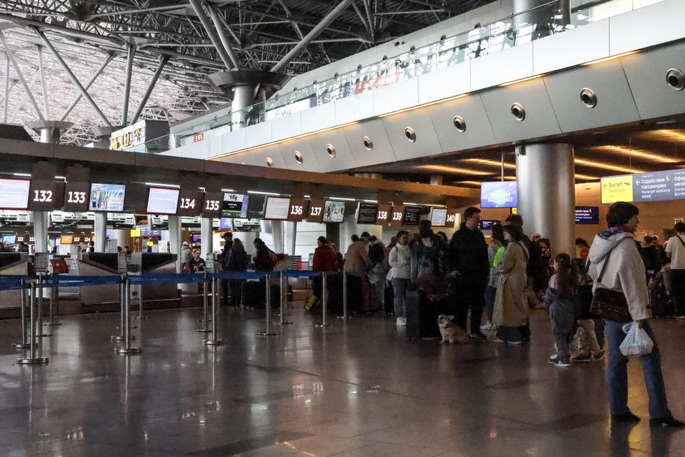 Passengers queue at check-in desks at Vnukovo International Airport