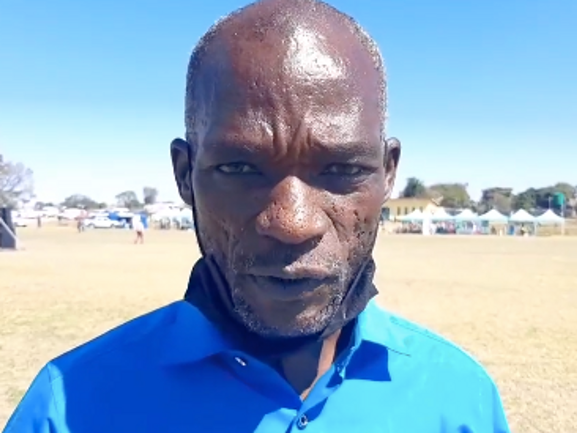 Pastor Maxwell Kapachawo talking in front of a camera.