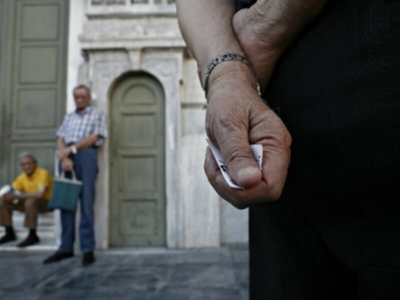 Pensioners line up outside the main gate of the national bank of Greece this week to withdraw a maximum of 120 euros .