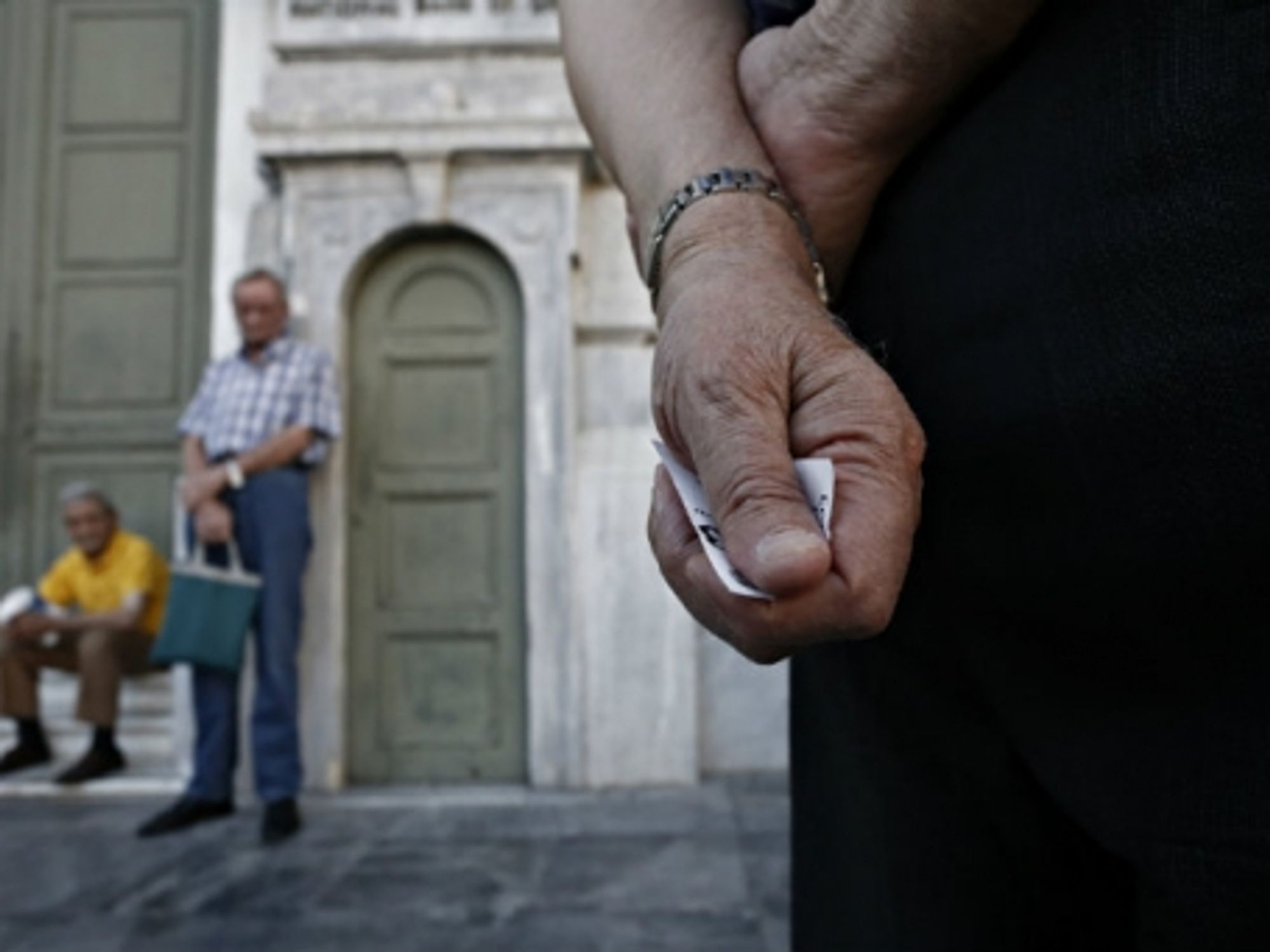 Pensioners line up outside the main gate of the national bank of Greece this week to withdraw a maximum of 120 euros .