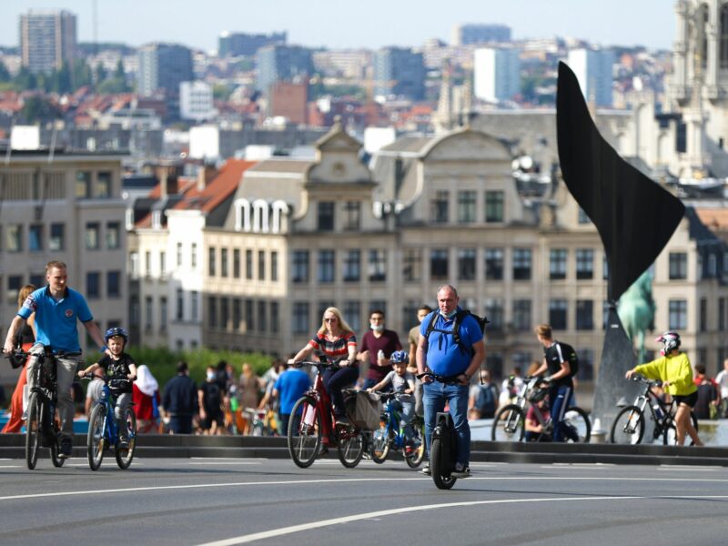 People bike and scooter on Car Free Sunday in Brussels.