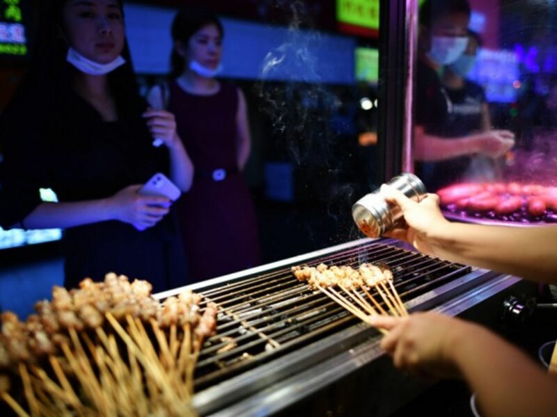 People buying food at a snack street in Haikou
