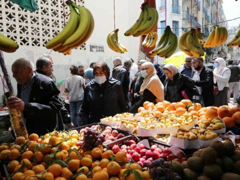 People buying food in a market on the first day of the month of Ramadan in Algiers