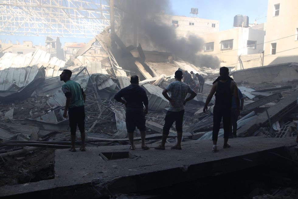 People gather at a destroyed building after an Israeli airstrike in the Al-Maghazi refugee camp, central Gaza Strip, on Oct. 24, 2024.