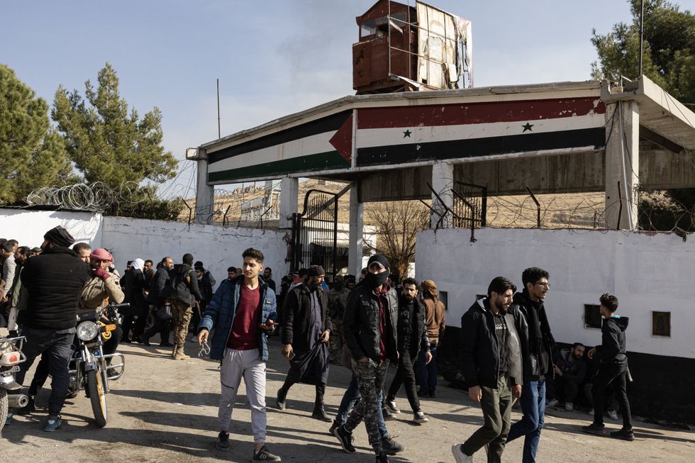People gather at the Sednaya prison in Damascus looking for loved ones on December 9, 2024