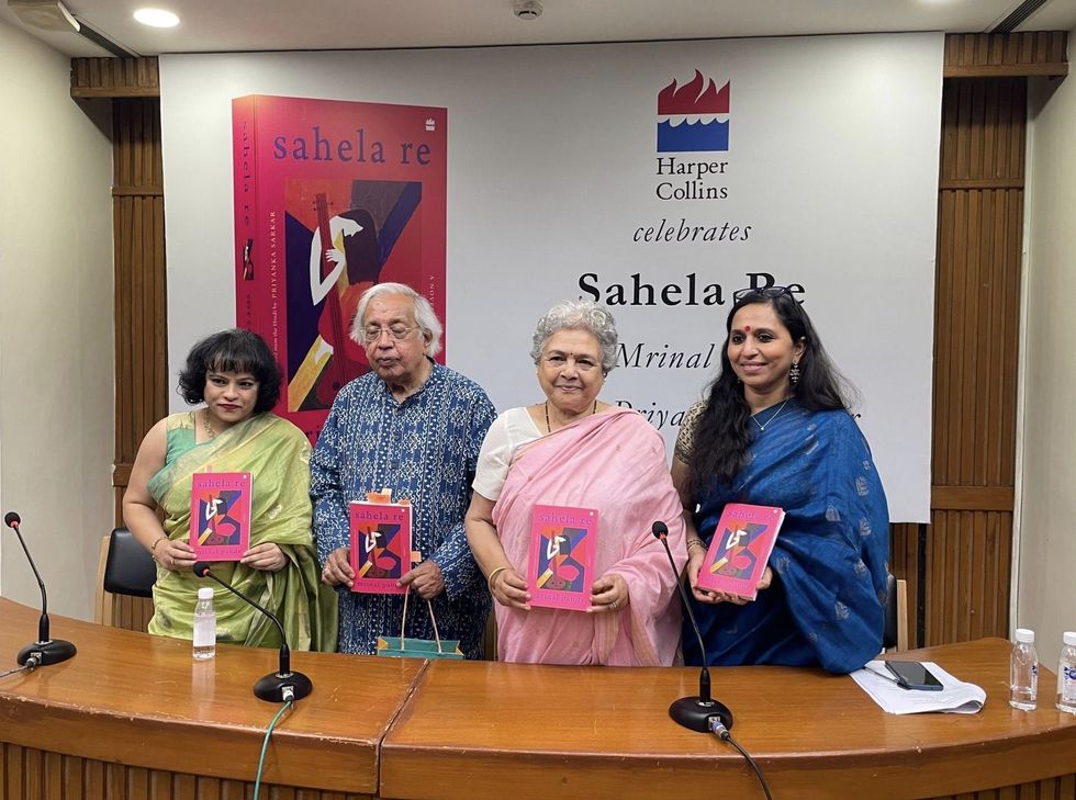 People holding Mrinal Pande’s book.