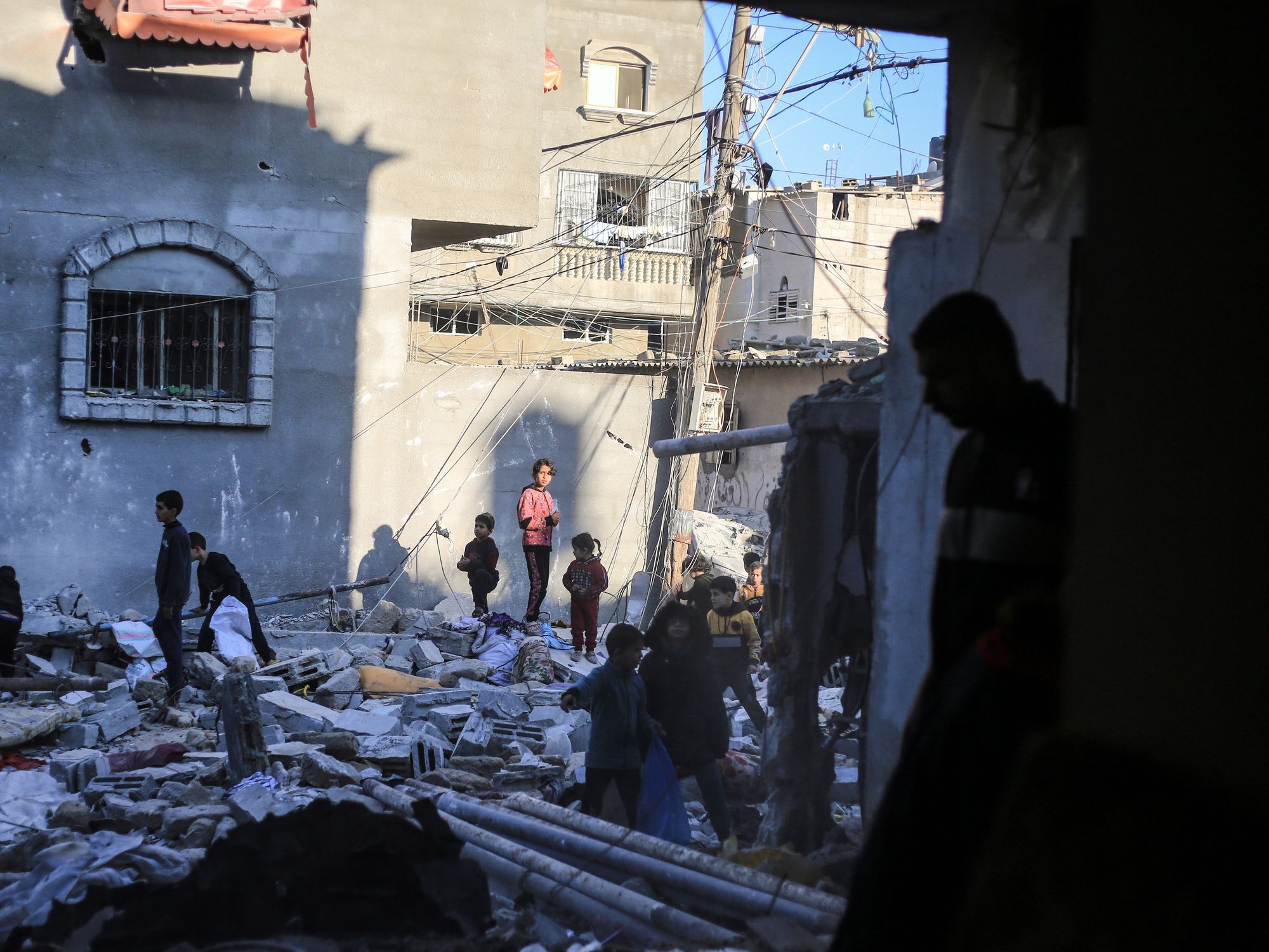 People inspect a damaged building after an Israeli raid on Rafah in the southern Gaza Strip