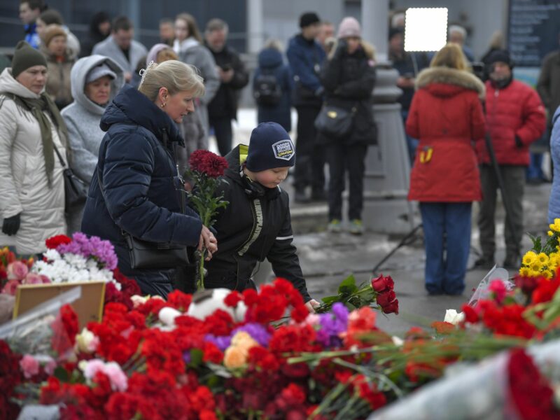 People lay flowers to mourn victims of a terrorist attack at the Crocus City Hall in Moscow, Russia, on March 22, 2024.