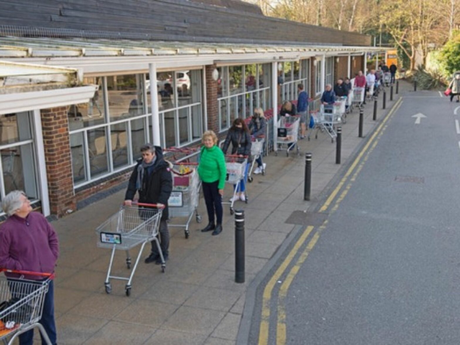 People lining up at a grocery store in South East London