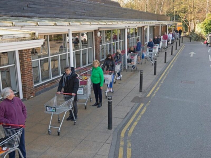 People lining up at a grocery store in South East London