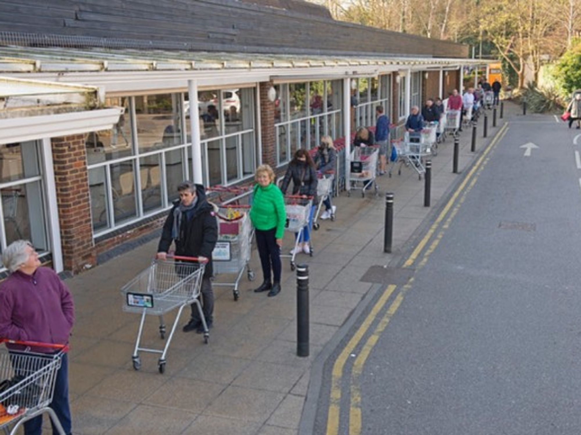 People lining up at a grocery store in South East London