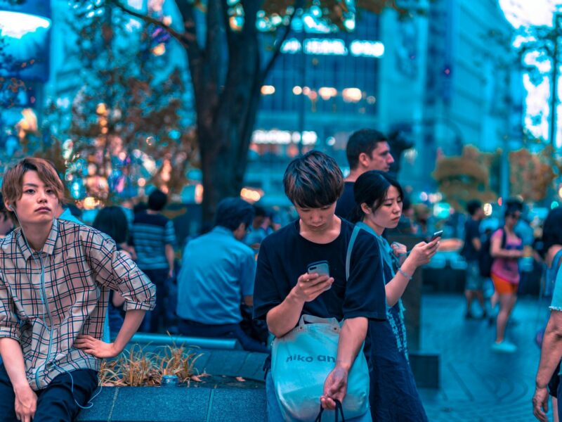 People looking at their smartphones in Shibuya, Japan.