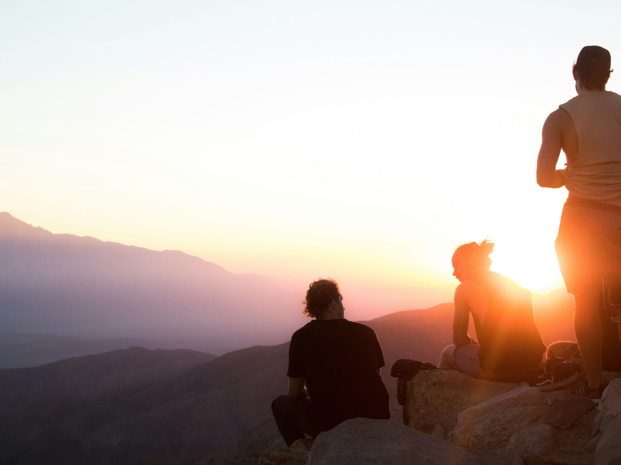 People on a mountain staring off into the distance.