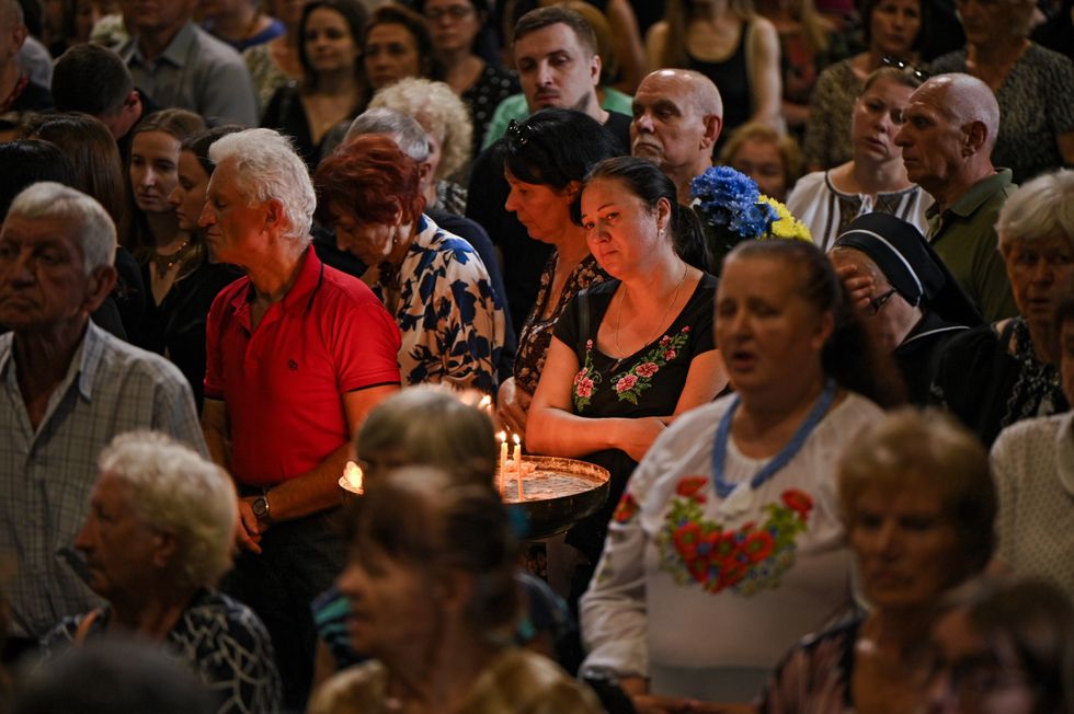 People pay their last respects to linguistic professor and former MP Iryna Farion, who was shot dead on the street on July 19