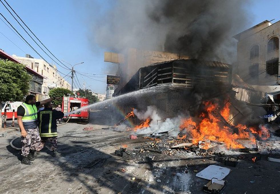 People put out a fire that erupted in a vegetable market