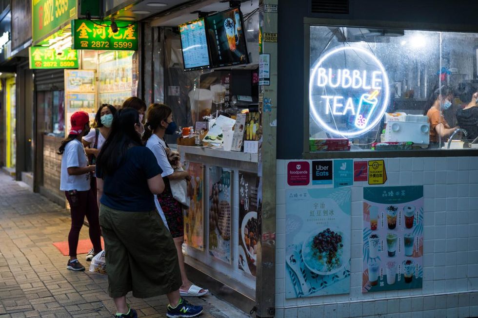 People queue up in front of a bubble tea shop in Hong Kong