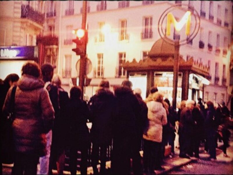 People queuing outside a newsstand in Paris