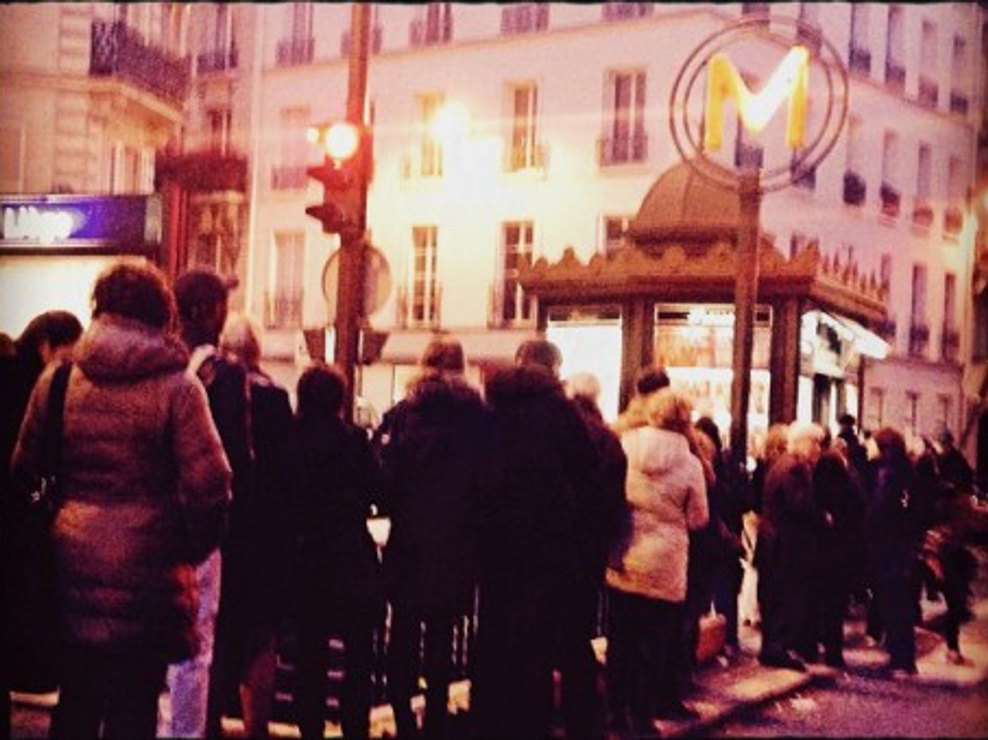 People queuing outside a newsstand in Paris