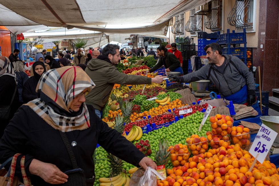 People shopping in street markets buying fresh fruits.