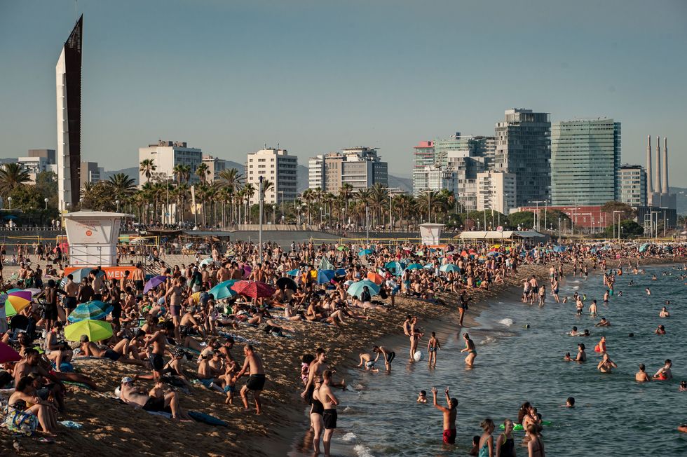 People swimming at a beach in Barcelona, Spain