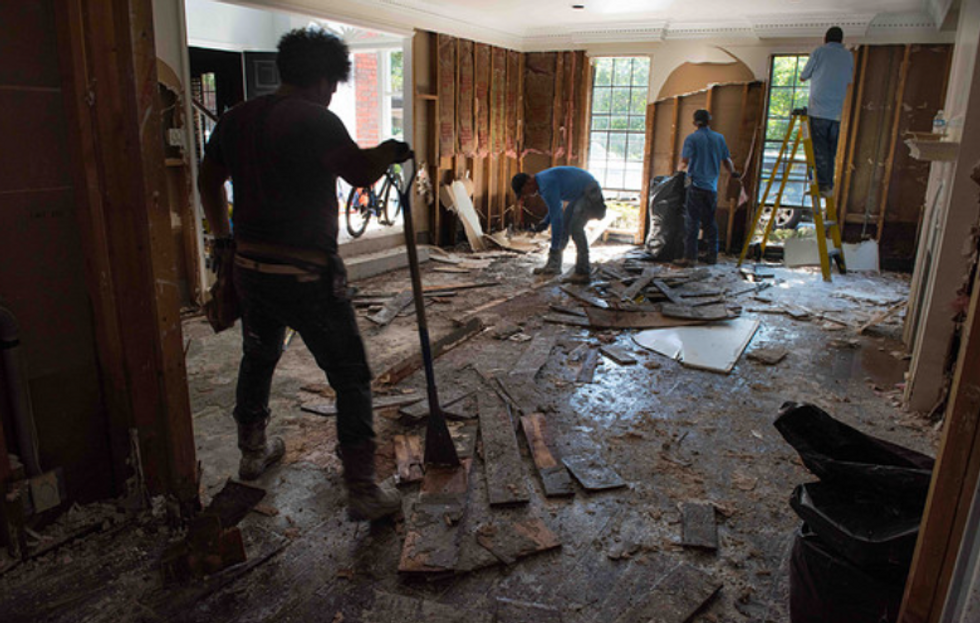 people taking down the floors of a house