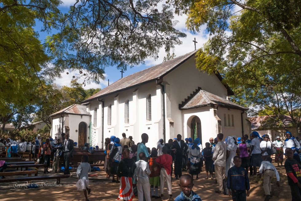 People waiting outside a church.
