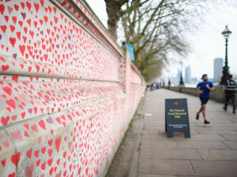 People walk past the COVID-19 Memorial Wall in London, in March 2021.
