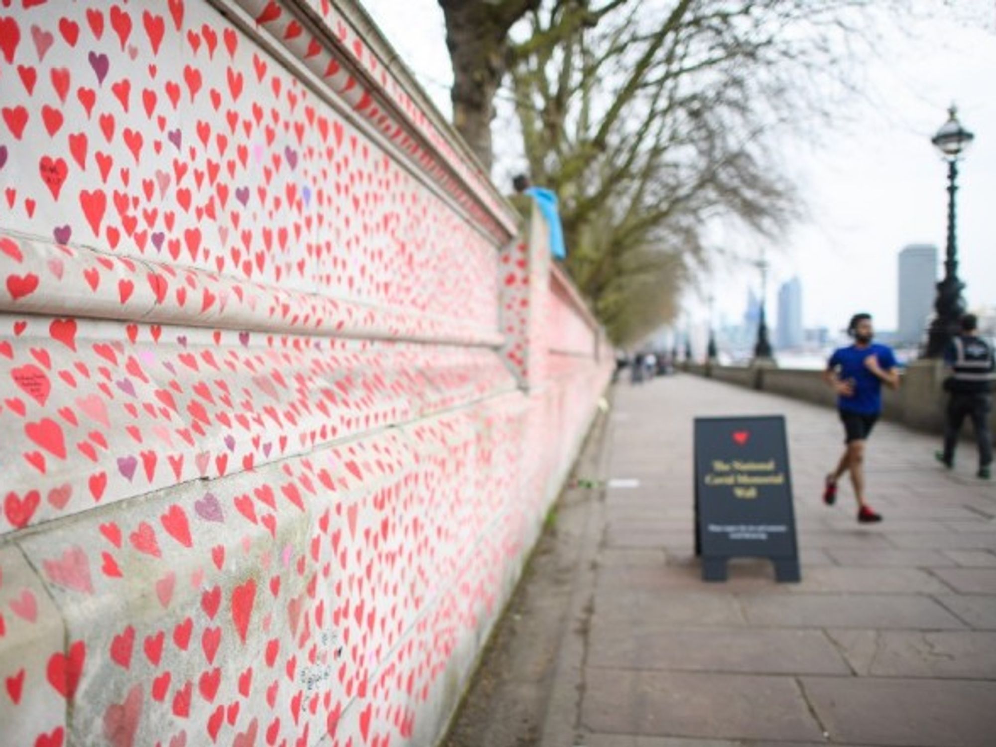 People walk past the COVID-19 Memorial Wall in London, in March 2021.