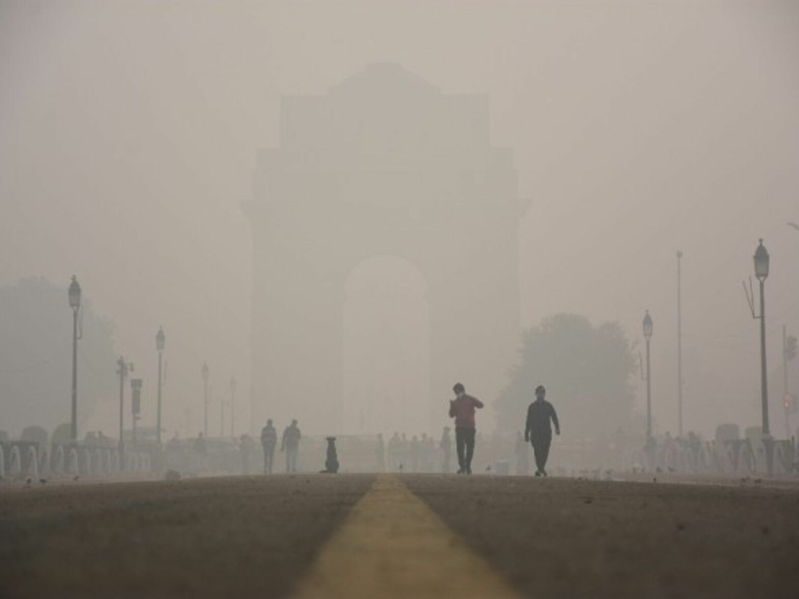 People walking amid heavy smog in New Delhi