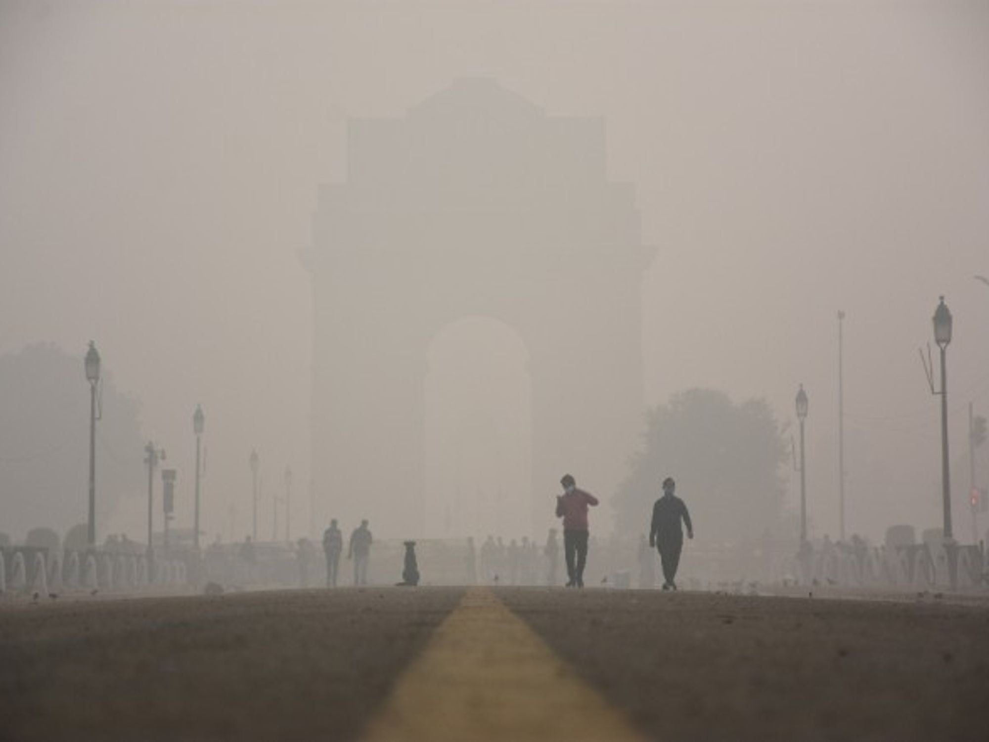 People walking amid heavy smog in New Delhi
