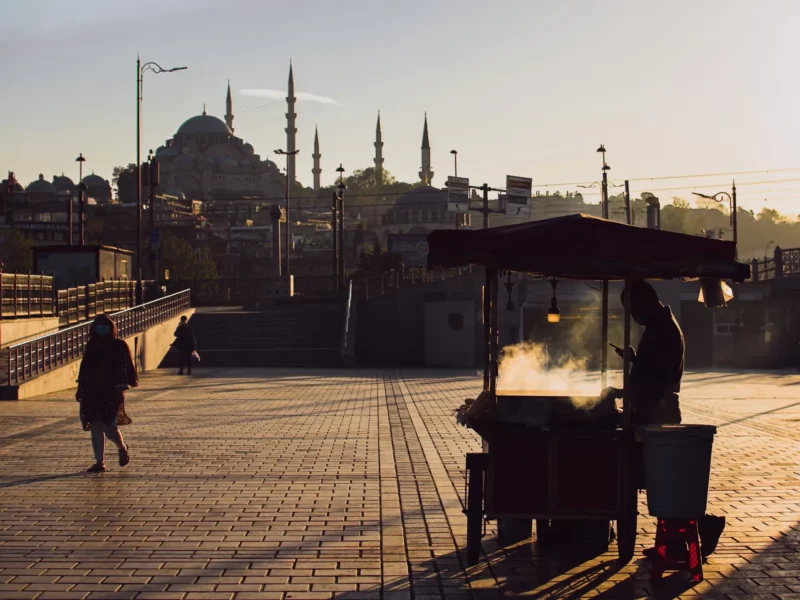 People walking by a mosque.​