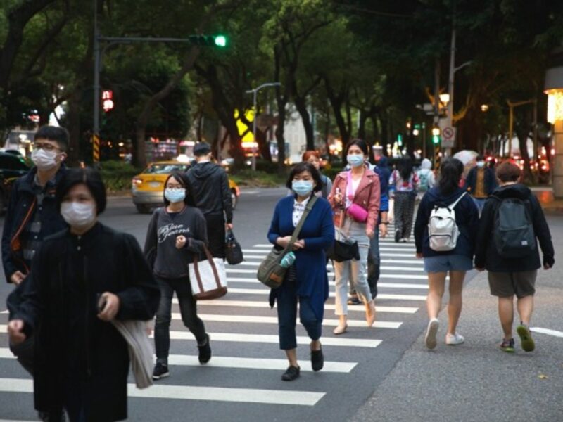 People wearing masks walk in the street in Taipei, Taiwan.