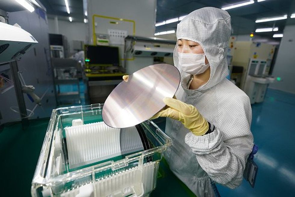 Person holding a semiconductor.