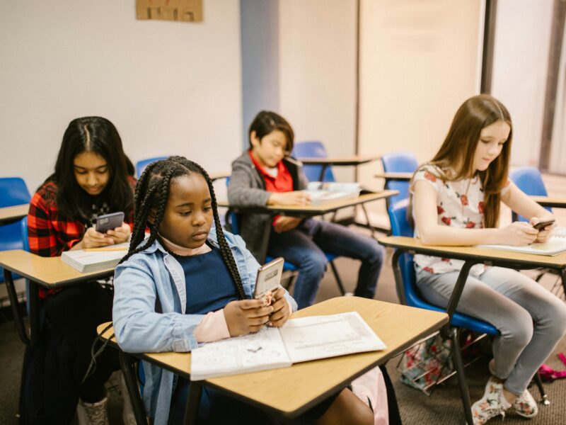 Kids on their phones at school.