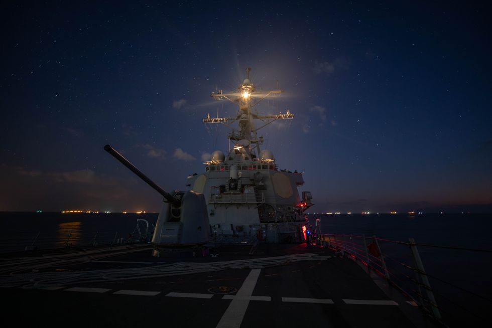 photo at night of USS Carney warship