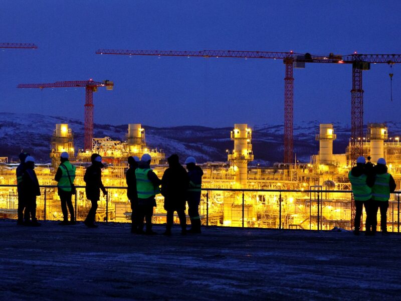 photo at night of workers at a gas plant
