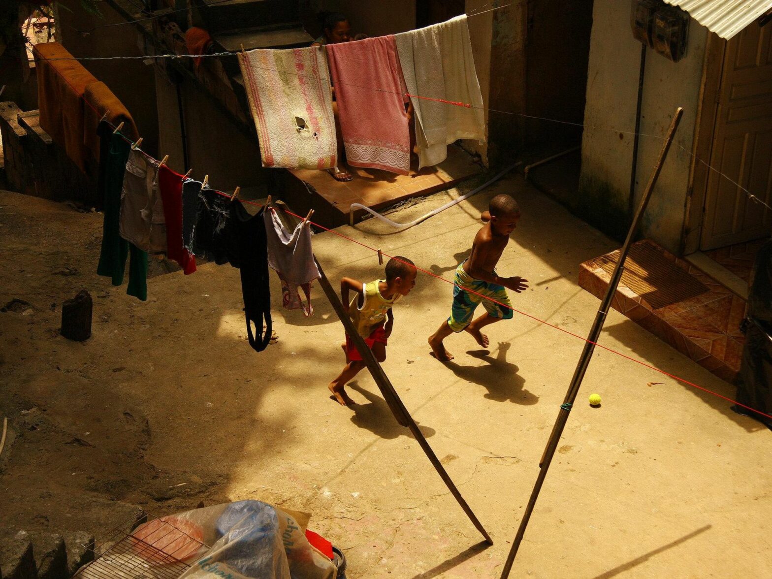 Photo from above of two boys playing soccer with a tennis ball