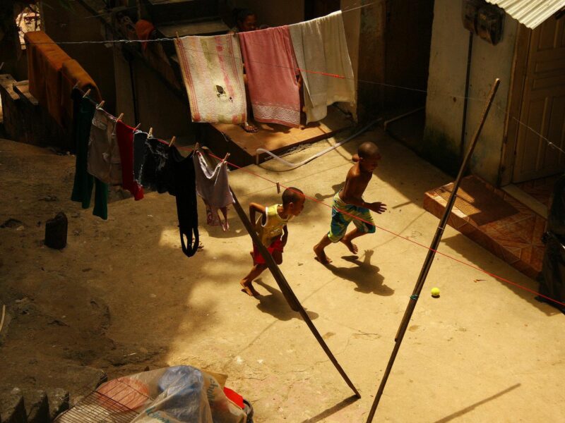 Photo from above of two boys playing soccer with a tennis ball