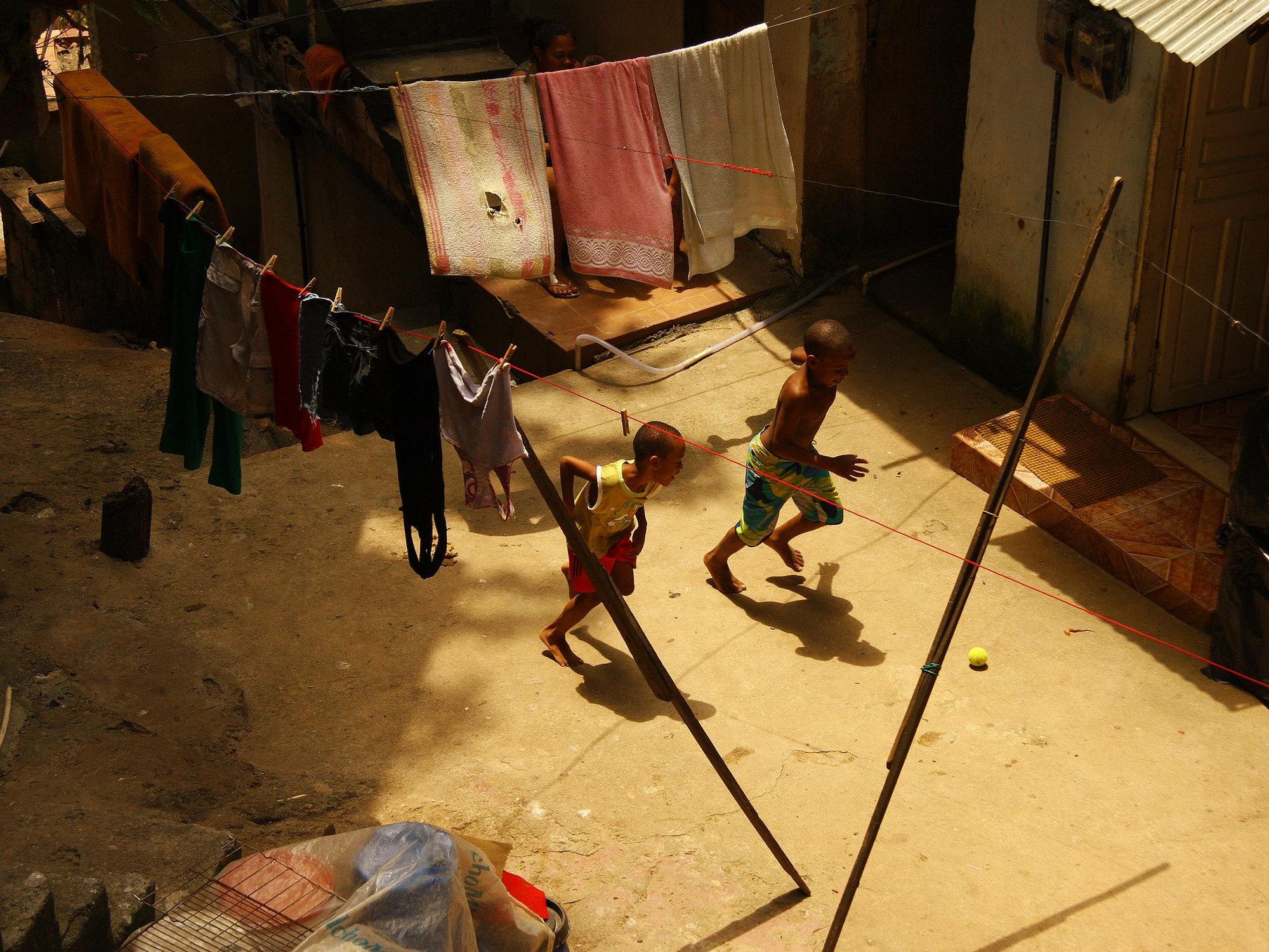 Photo from above of two boys playing soccer with a tennis ball