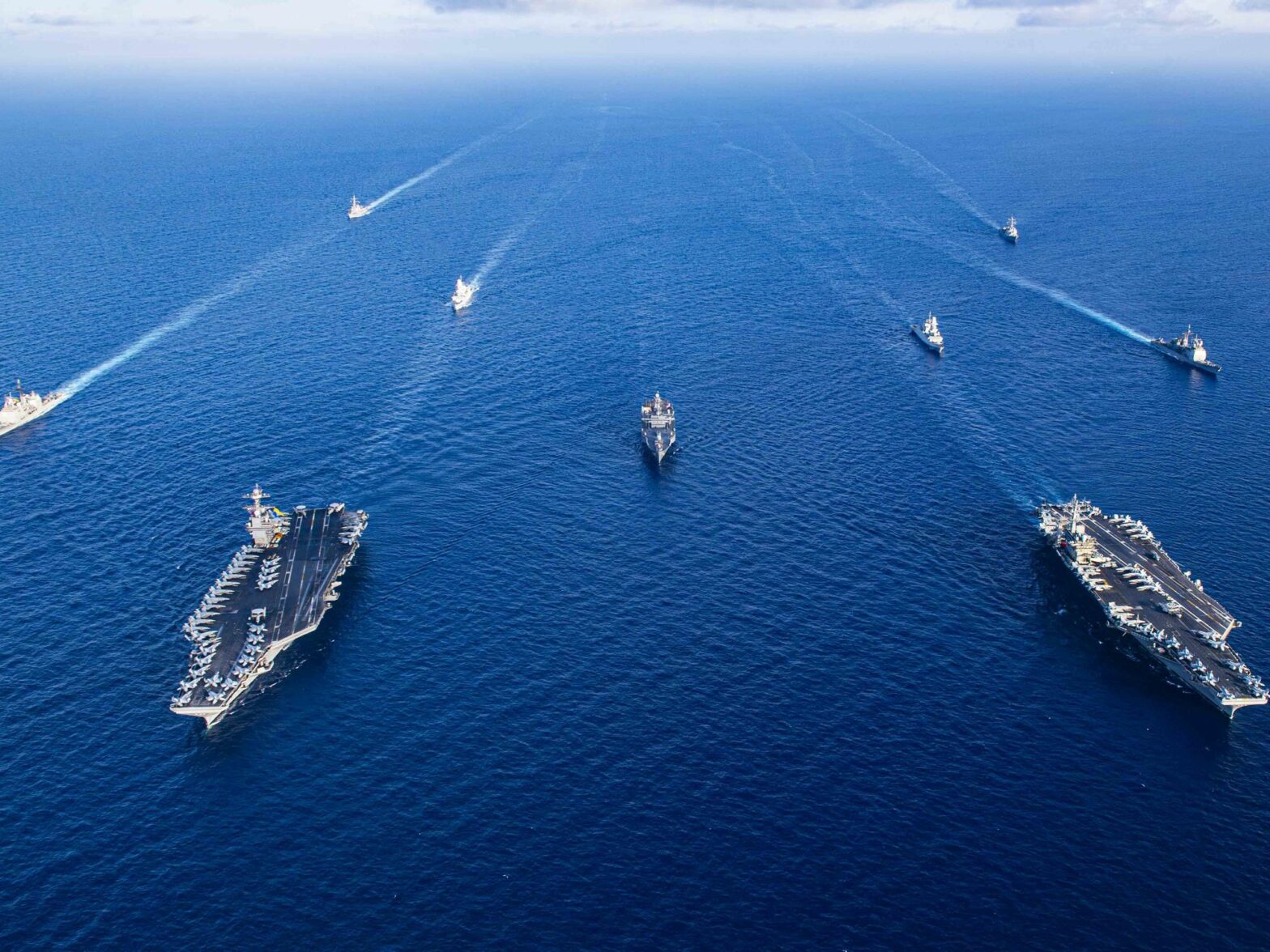 photo from air of navy ships in formation