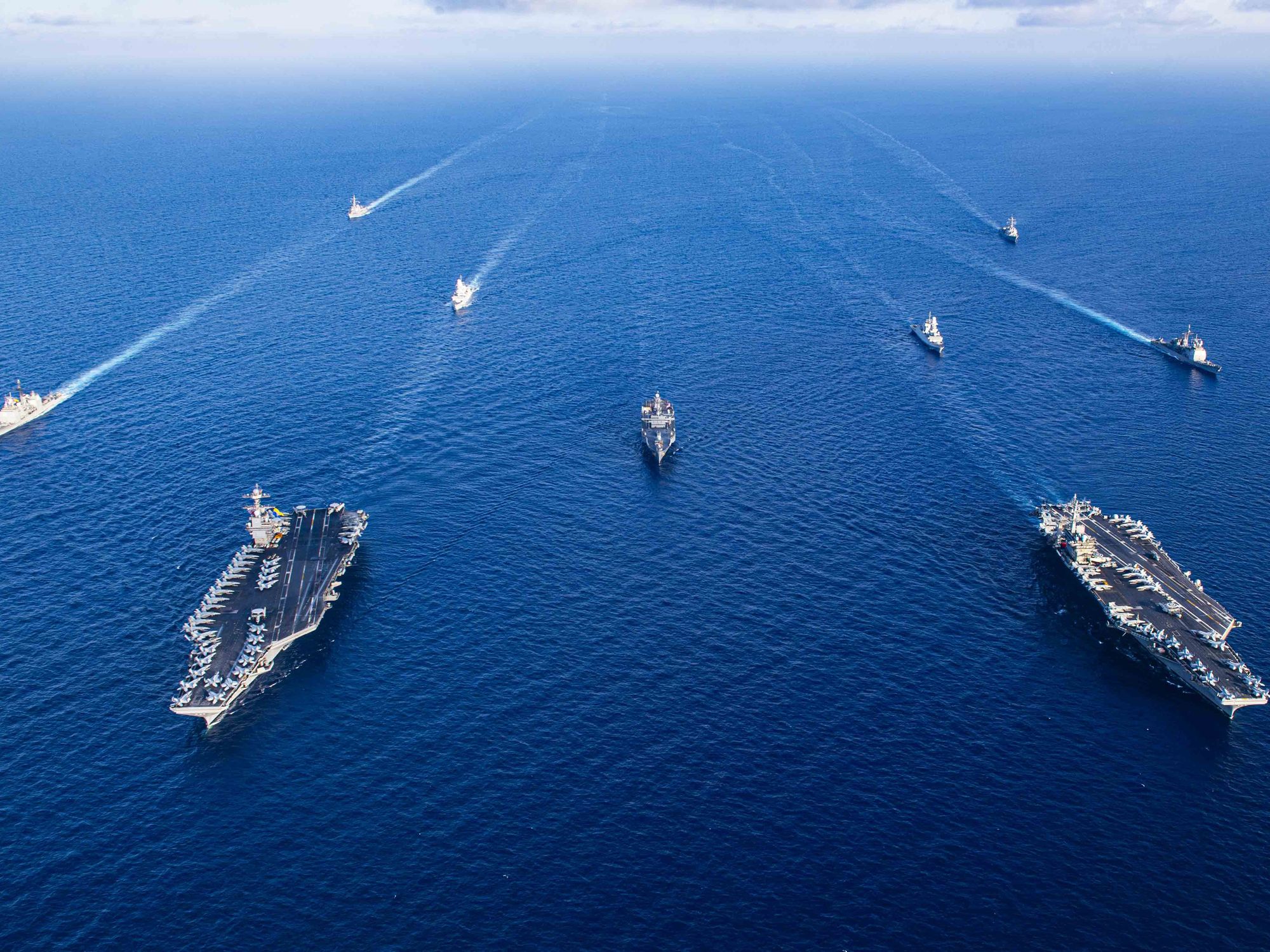 photo from air of navy ships in formation