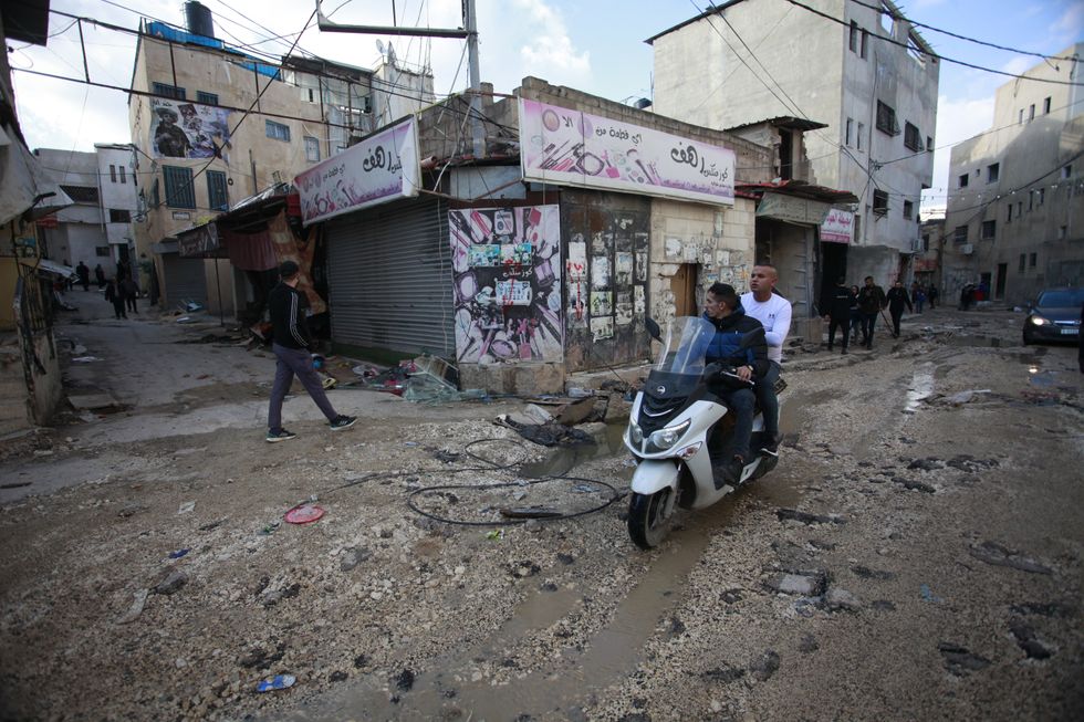 photo of 2 men on a scooter