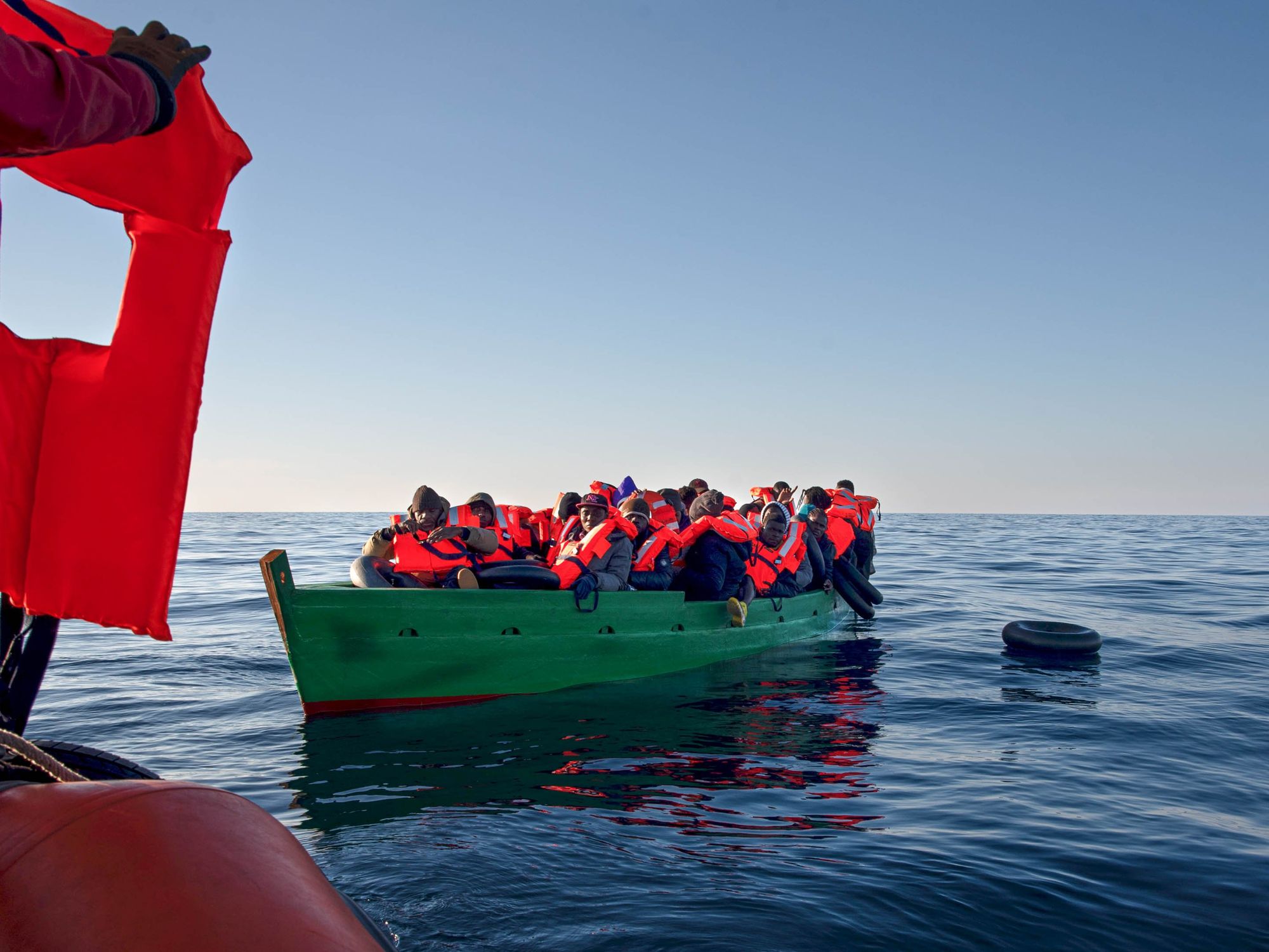 Photo of 31 migrants 33 miles off the coast of Tunisia minutes before being brought to safety by the rescue team of the Basque NGO SMH.