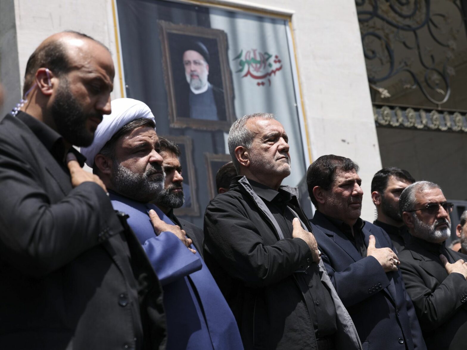 photo of 5 men praying