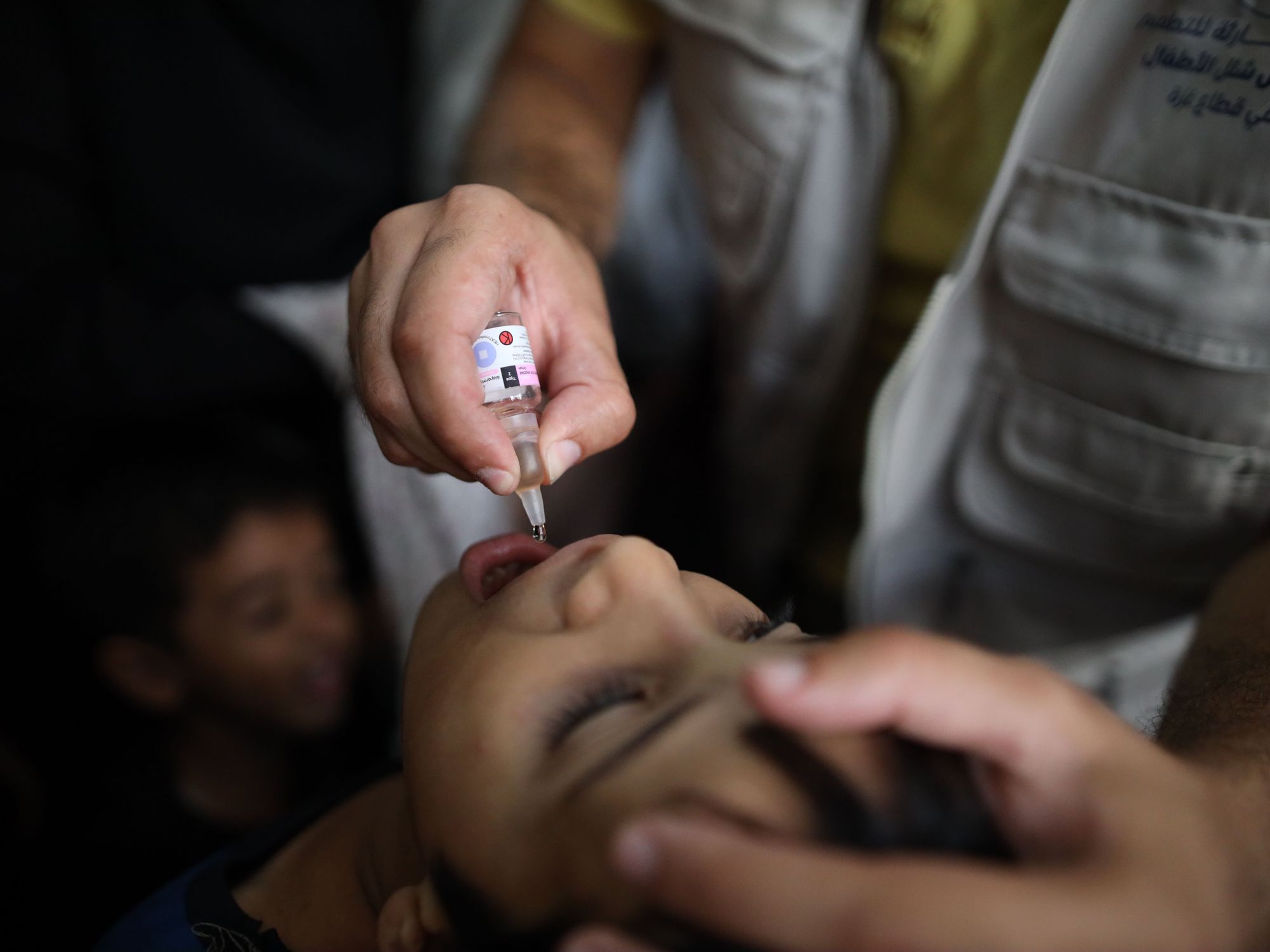 Photo of a A child receives a dose of the polio vaccine