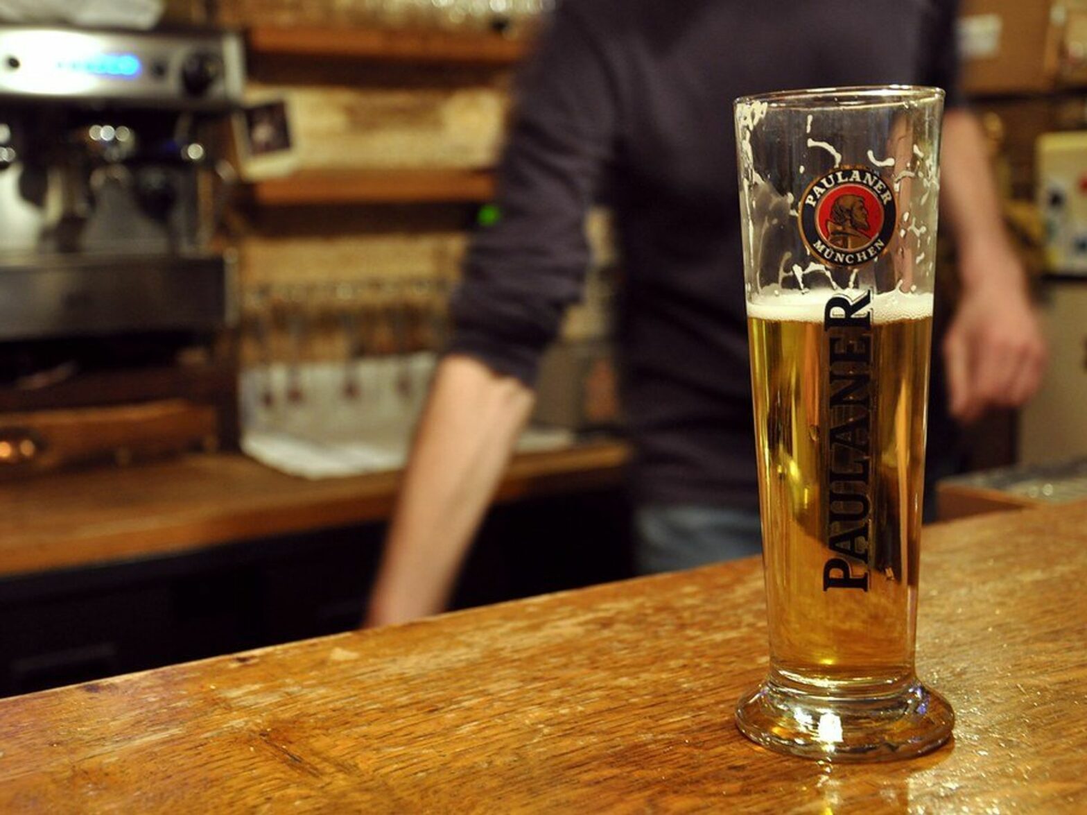 photo of a beer half full on a bar